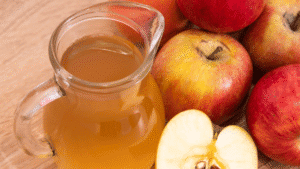 Fresh apple cider and whole apples for health and wellness.